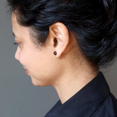 sheila of satin crystals wearing dark red garnet stud earrings