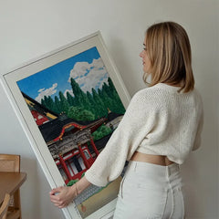Red Temple by Hasui Kawase print held up against a living room wall