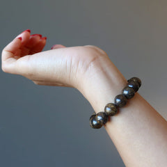 hand wearing a bronzite bracelet