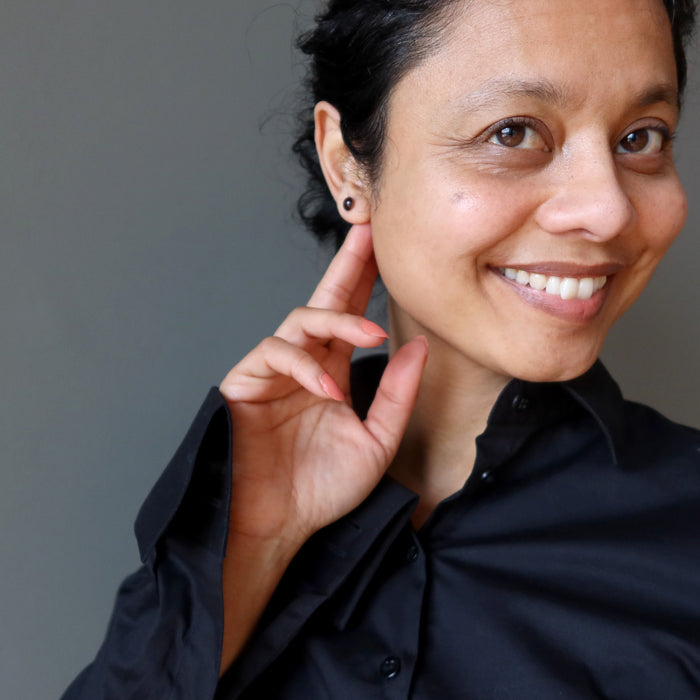 sheila of satin crystals wearing dark red garnet stud earrings