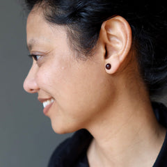 sheila of satin crystals wearing dark red garnet stud earrings