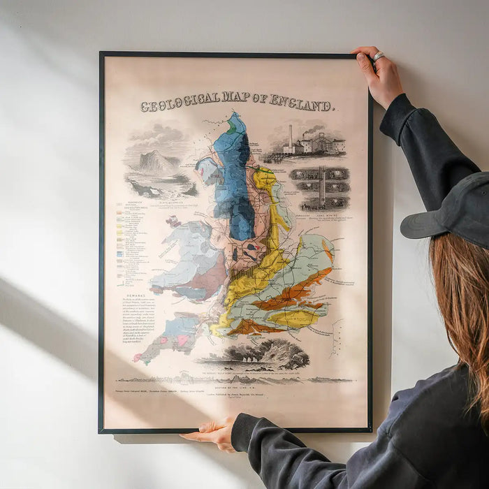 Geological map of England art print being hung on a wall in a black frame