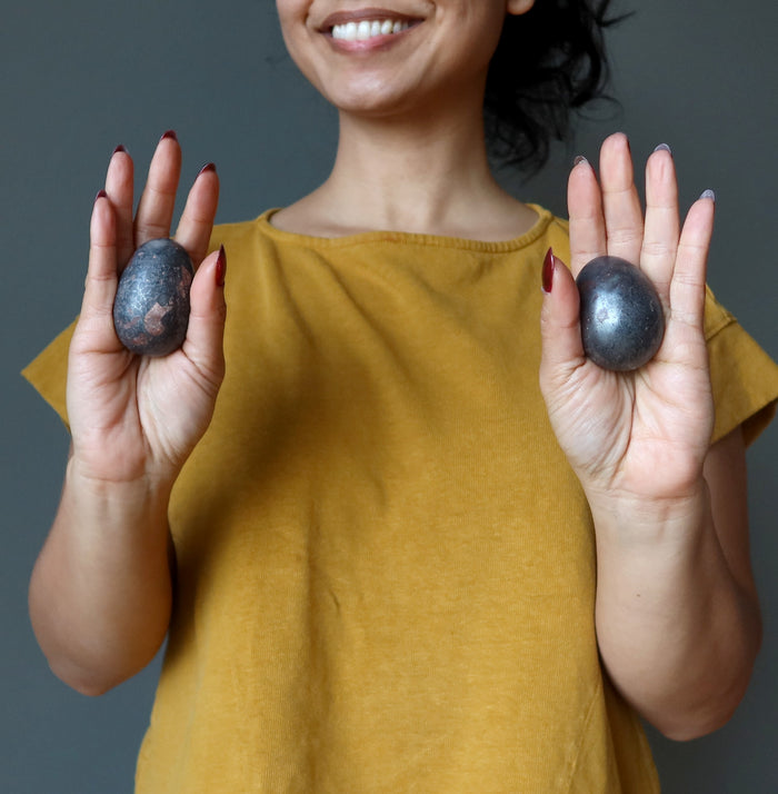 female with hematite eggs in each palm