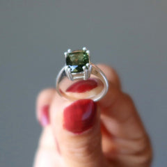 hand holding moldavite ring