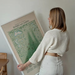 Panoramic plan of the principal rivers and lakes art print held up against a living room wall