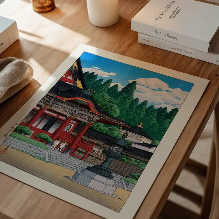 Red Temple by Hasui Kawase, Japanese woodblock print unframed on a home office desk
