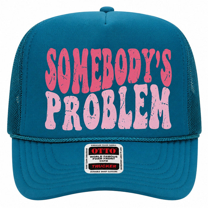 Tea Shirt Shoppe Wholesale teal trucker hat with pink distressed Somebody's Problem graphic and mesh back.