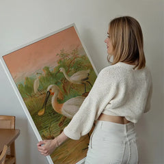 Spoonbill Vintage Bird Print by Johann Friedrich Naumann held up against a living room wall