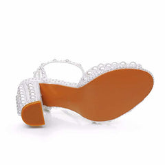 White chunky wedding sandals featuring pearl accents and a stylish design for brides